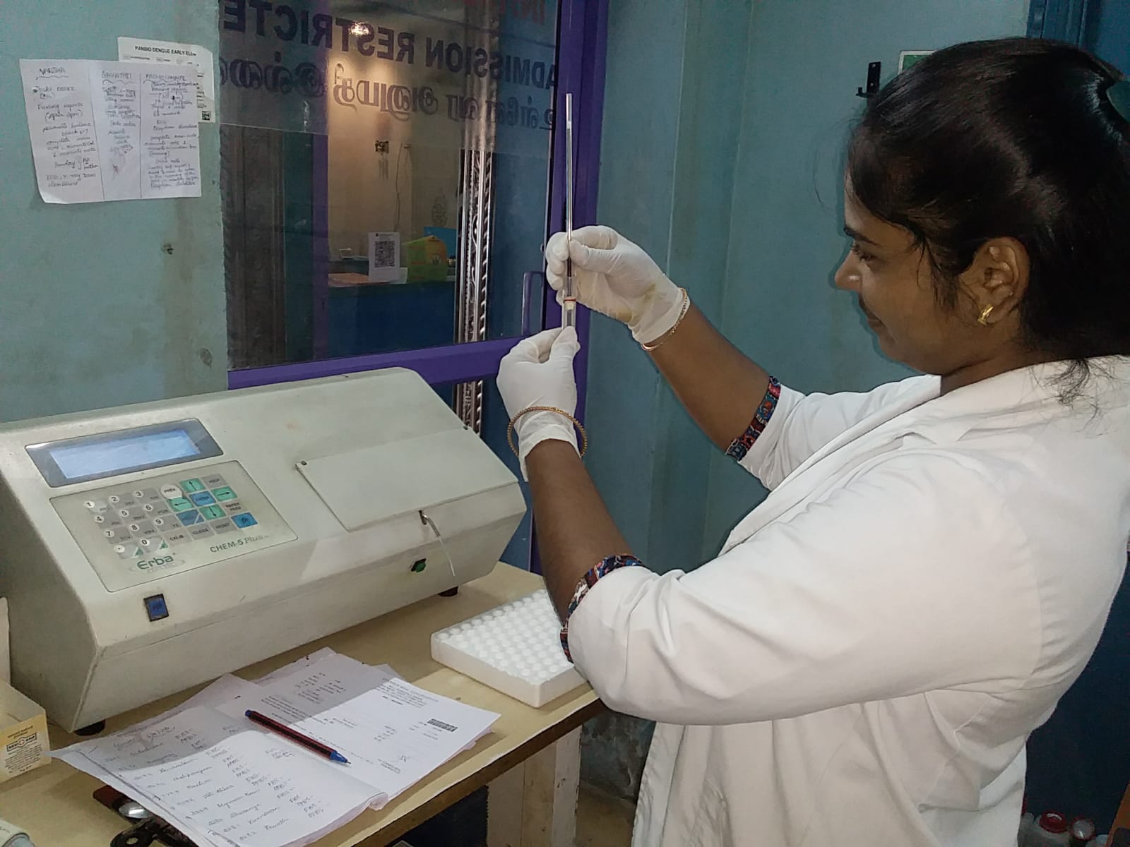 Student pipetting samples for a biochemistry test