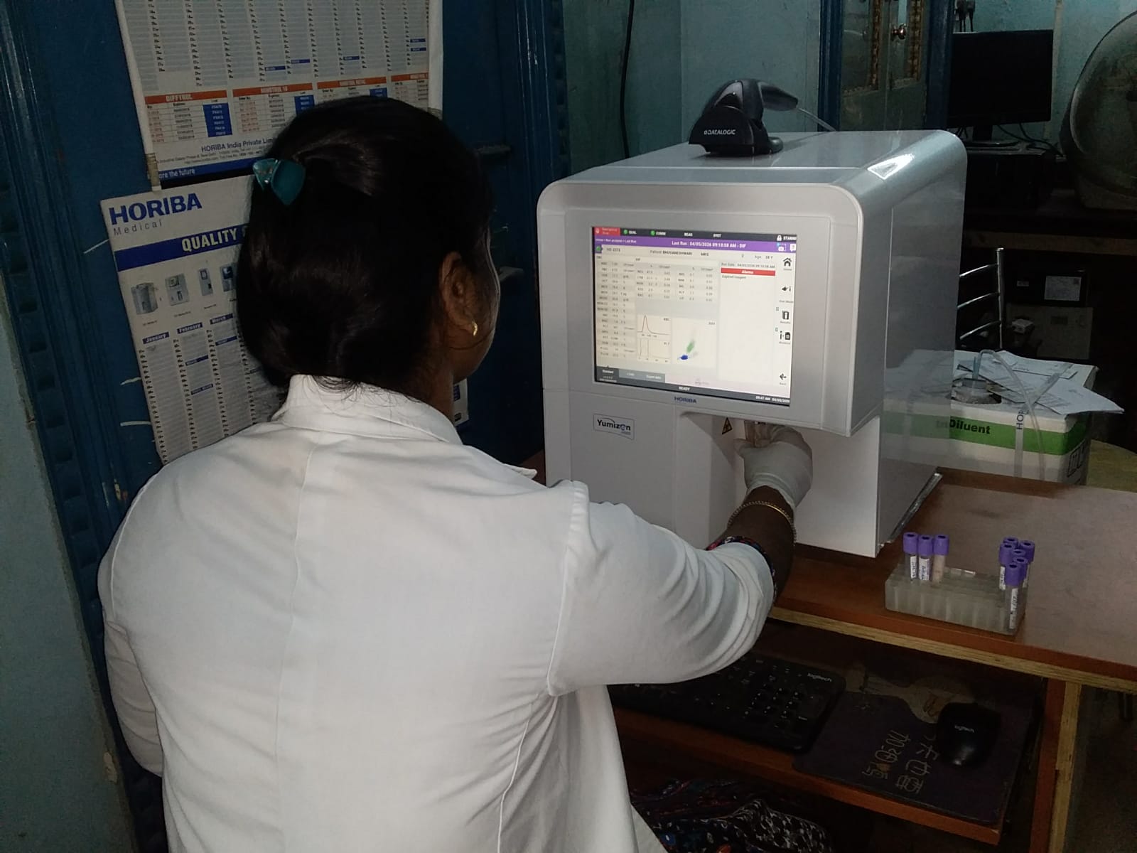 SIAHS student operating a Yumizon hematology analyzer during clinical lab training